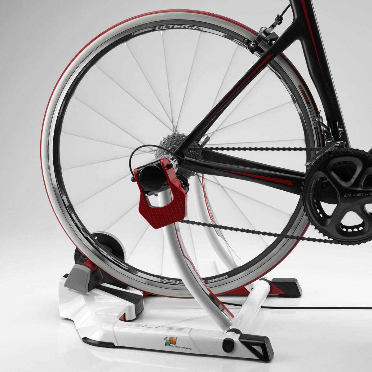 Carbon road bike rear wheel clamped in the Elite Qubo Power Mag Smart B+, side view