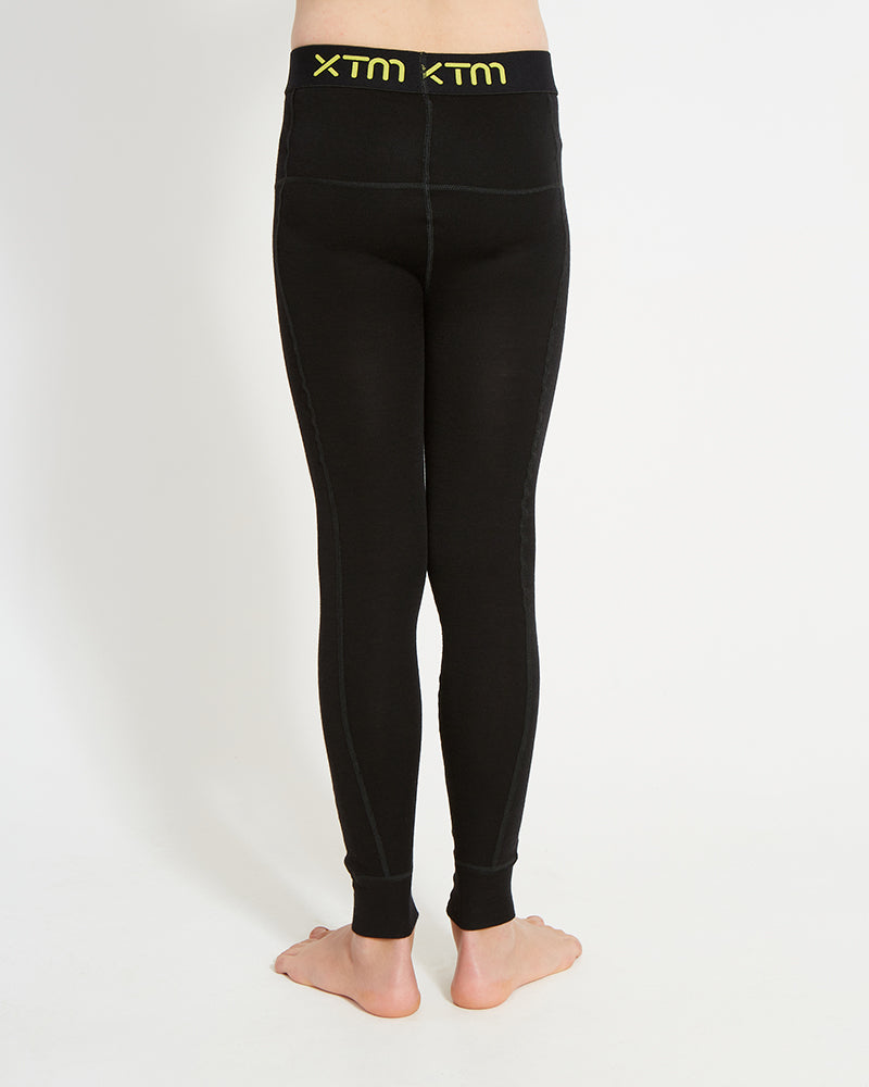 XTM Kids Alpine230 Merino Thermal Pants in Black, back view with the XTM logo waistband