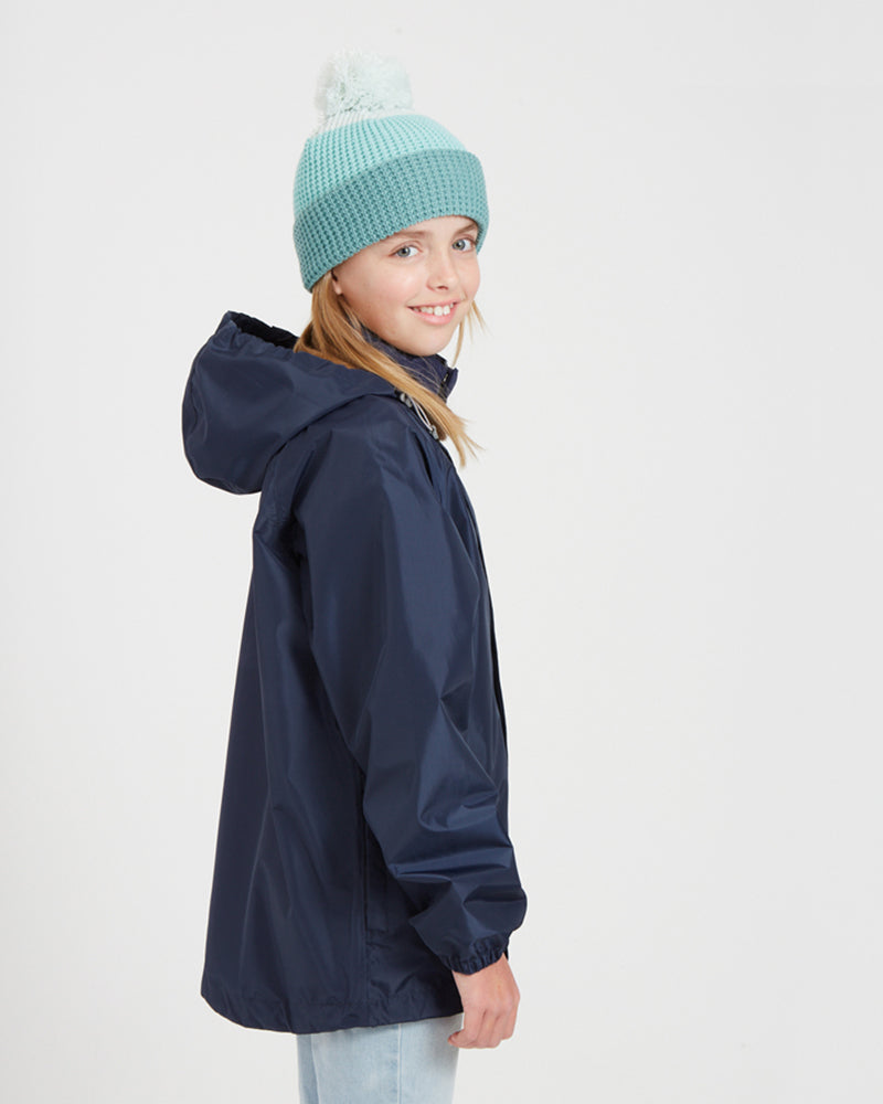 Side view of the XTM Kids Stash 2L rain jacket in Patriot Blue with the hood down