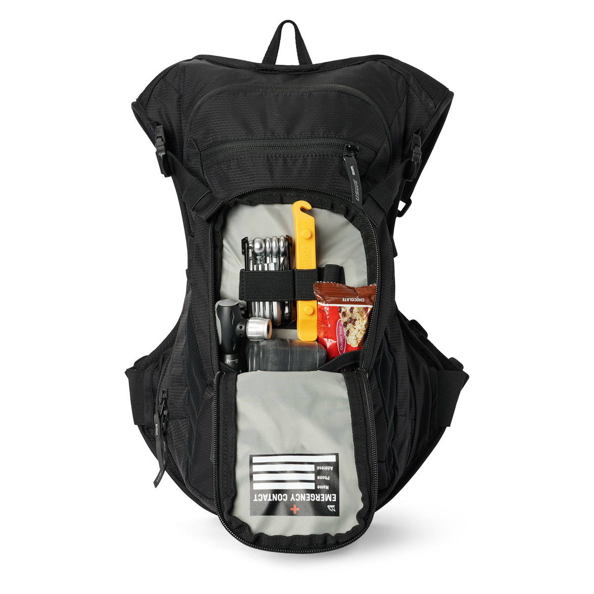 USWE MTB Hydro 9L in Black with the front pocket open, holding a multi-tool, a pump and snacks