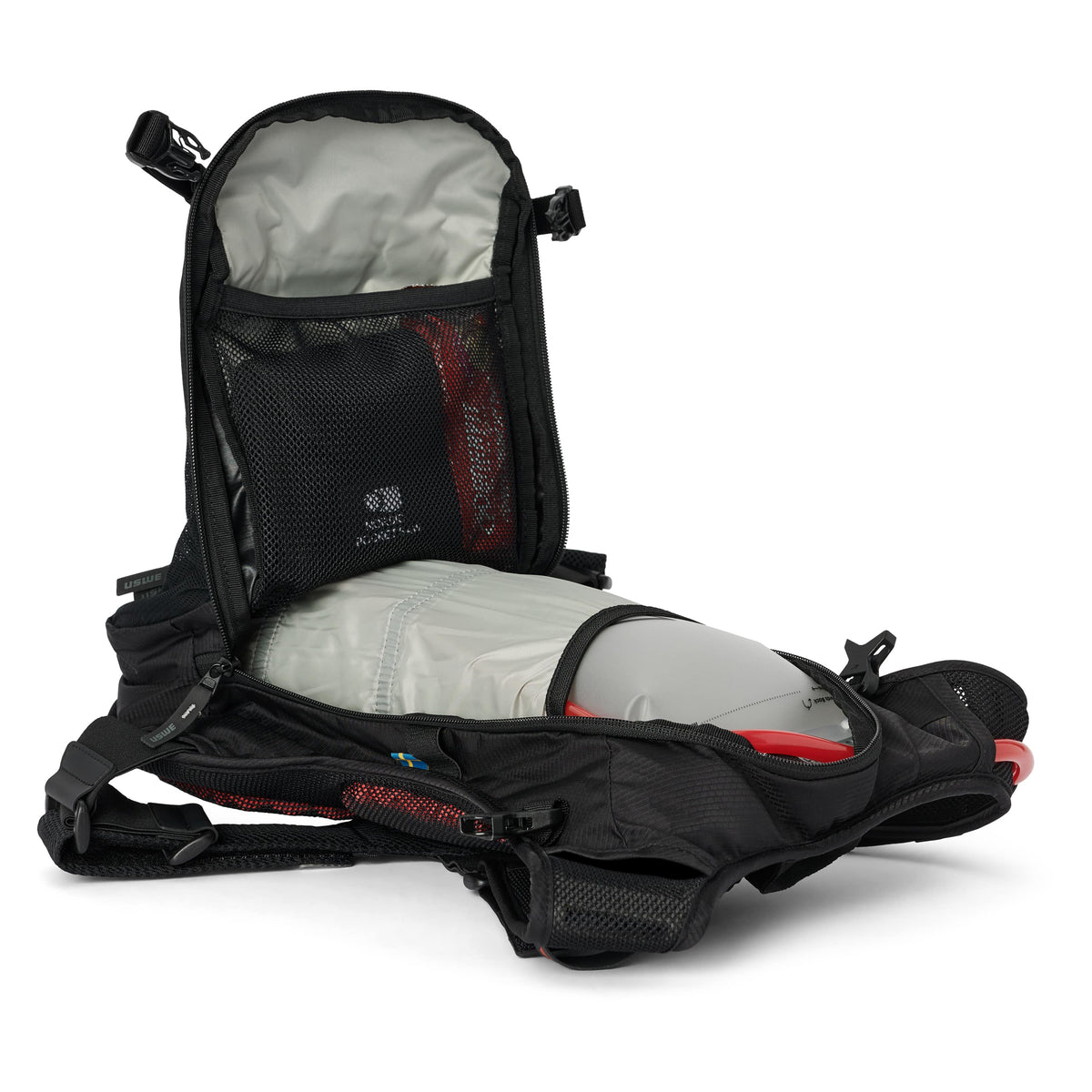 USWE MTB Hydro 9L in Black with the main compartment unzipped, showing the bladder sleeve