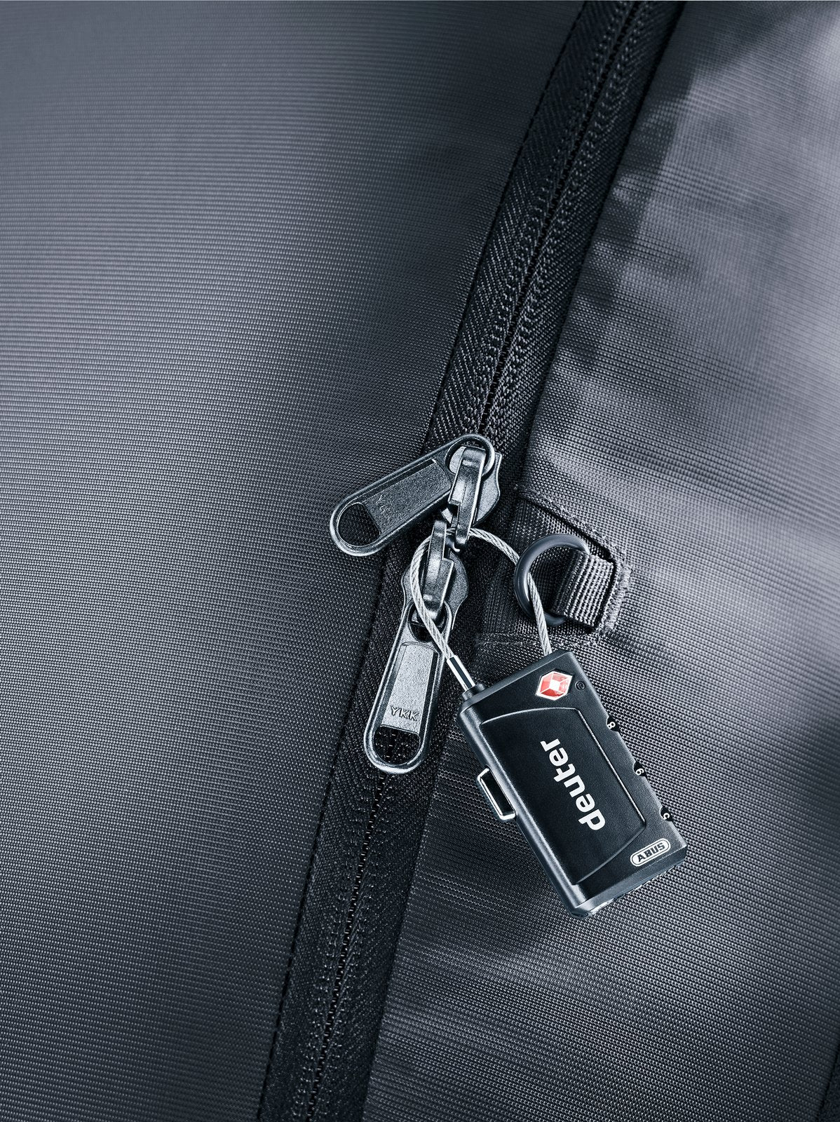 Close-up of the Deuter Access 55 lockable main zip in Black with a padlock (not included)