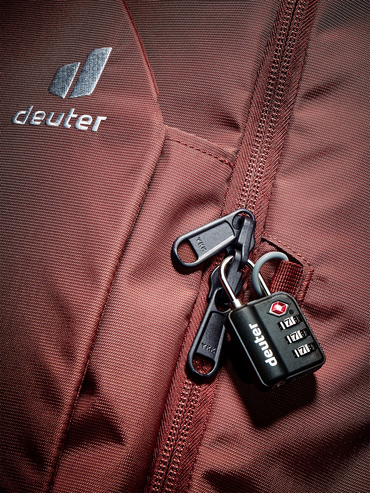 Close-up of the lockable zip on the Deuter Access Pro 60 SL in Caspia Raisin, padlock sold separately