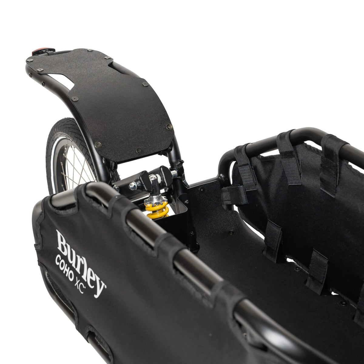 Close-up of the Burley Coho XC rear rack and yellow coil-spring shock above the wheel