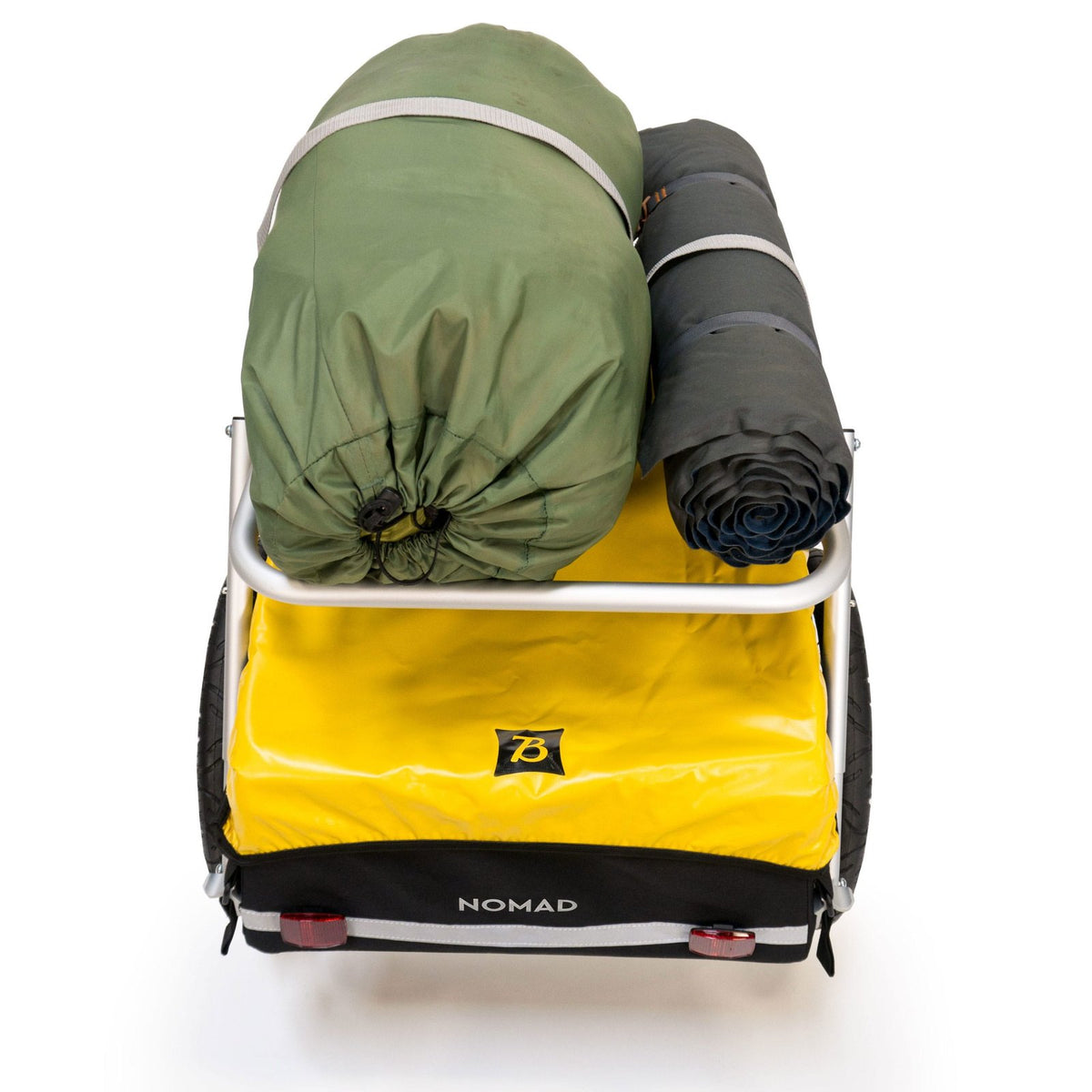 Burley Nomad Cargo Rack carrying a rolled green bag and a rolled grey mat strapped on top of a Nomad