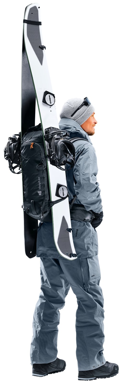Deuter Freescape Lite 26 worn by a man with a snowboard strapped vertically to the back, rear three-quarter view