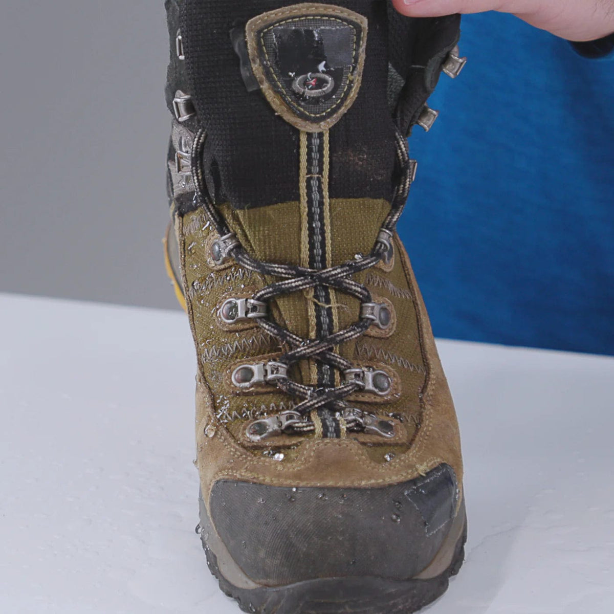 Front of a clean, damp brown and black hiking boot after washing