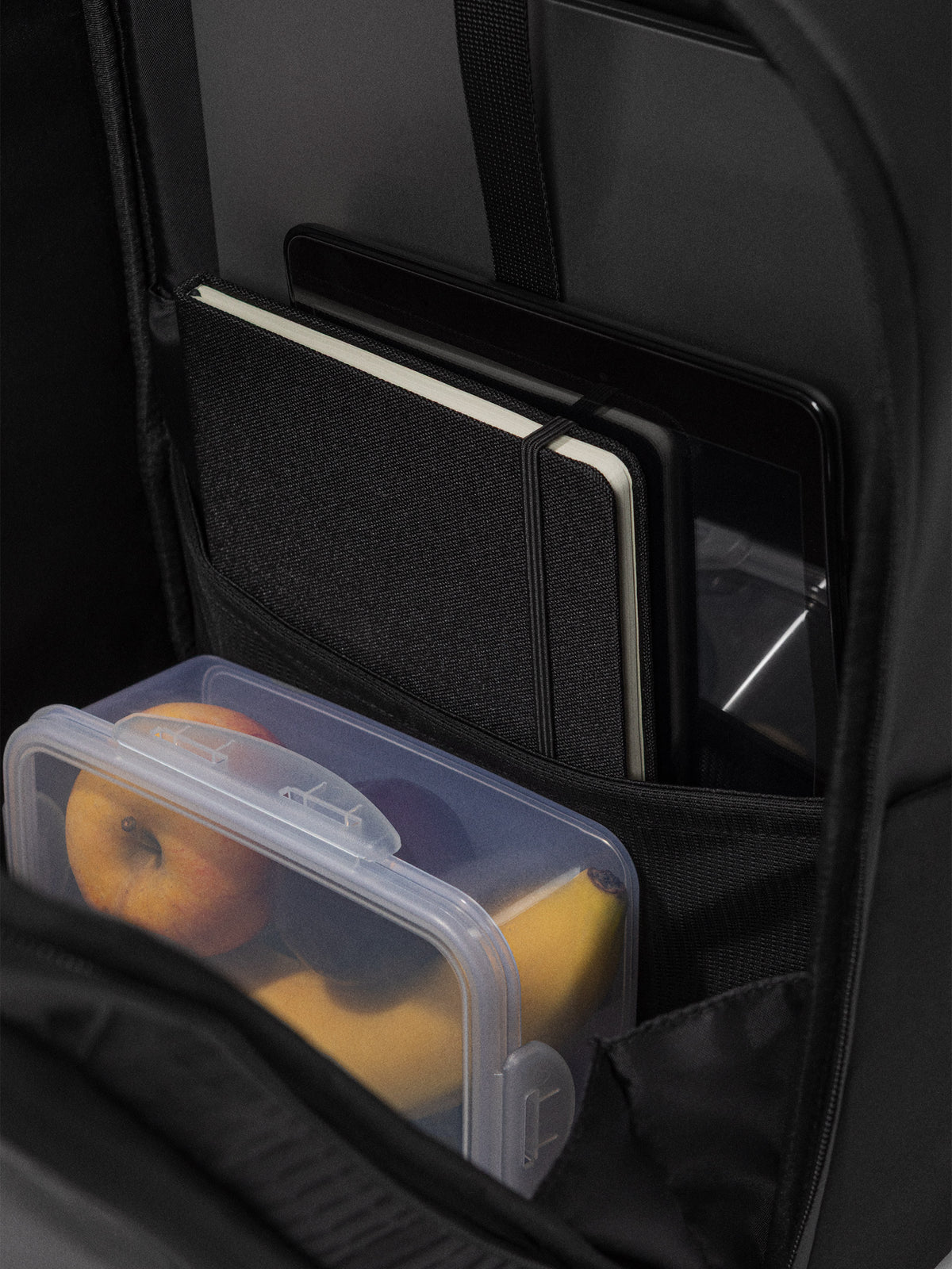 Main compartment of the Orca Casual Backpack with a laptop sleeve, notebook and lunch box