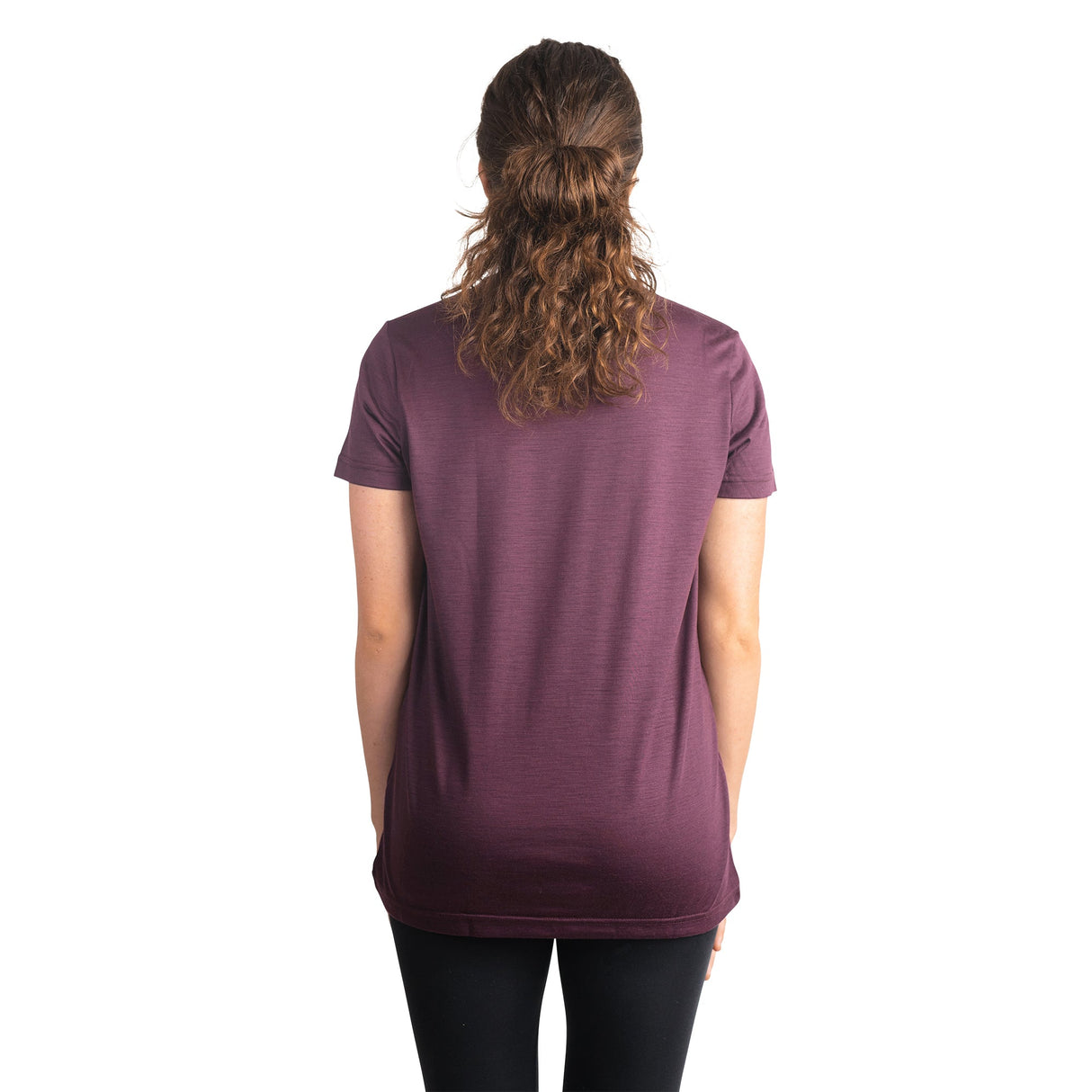 Back shot of Ottie Merino women's Plum short sleeve merino wool t-shirt on 166cm model who is wearing a size small