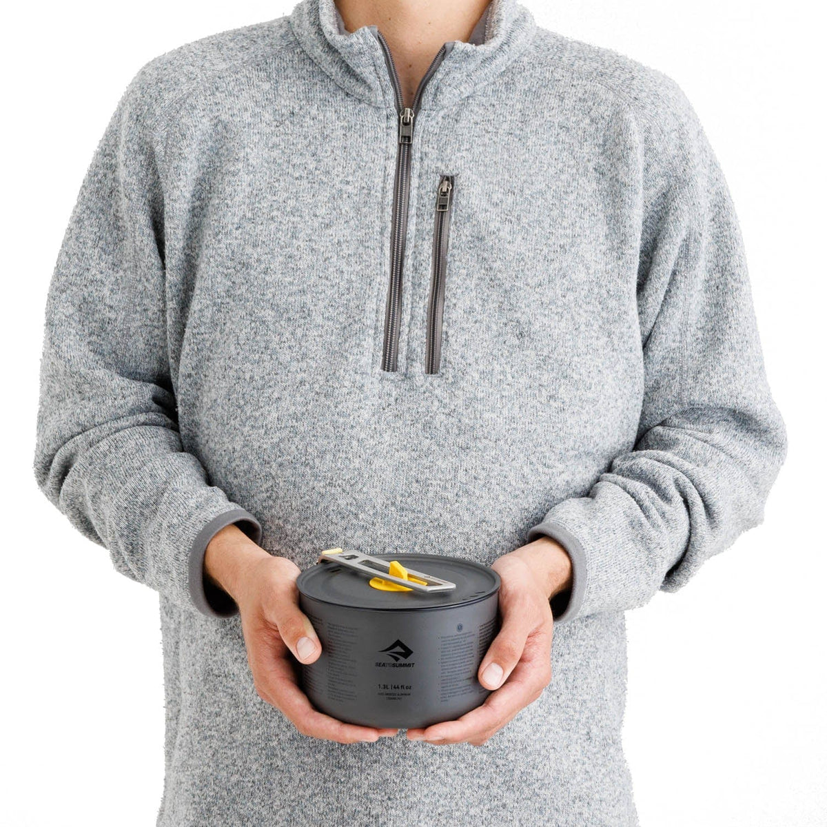 Person holding the packed Frontier cook set with the handle folded over the lid