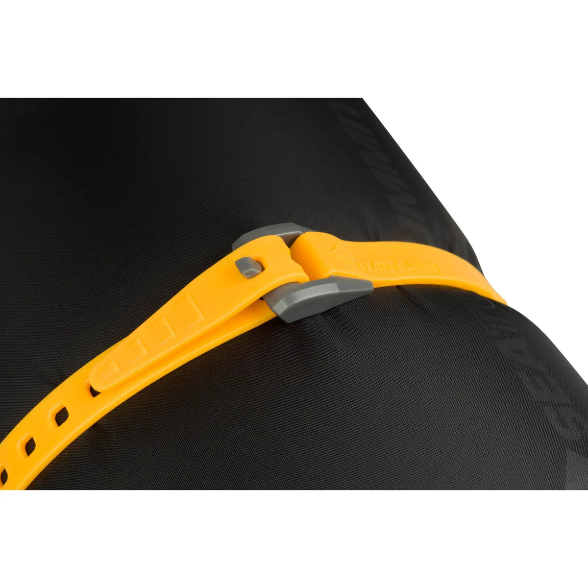 Yellow Stretch-Loc strap buckled across a black dry bag, buckle close-up
