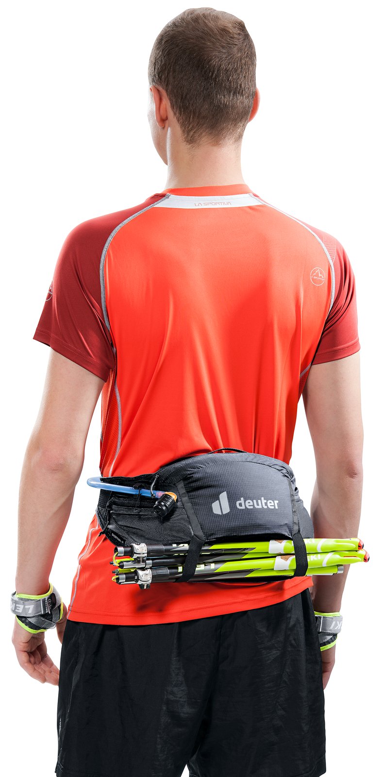 Runner wearing the Deuter Shortrail III with folded trekking poles on the belt