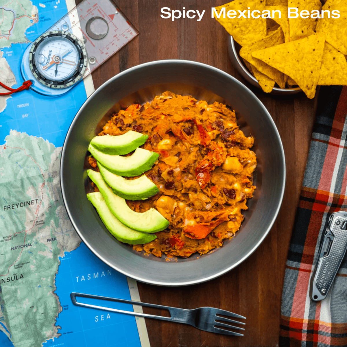 Bowl of Campers Pantry Spicy Mexican Beans with avocado slices and corn chips