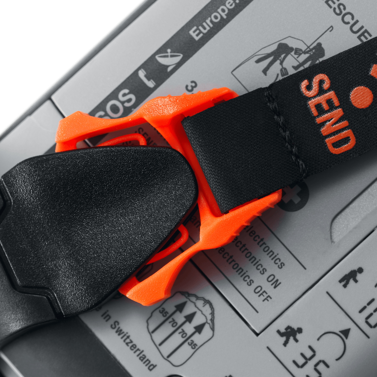 Close-up of the orange clip and SEND-marked strap on the back of a Mammut Barryvox