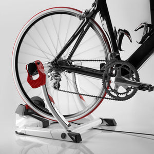 Road bike mounted on the Elite Qubo Power Mag Smart B+ trainer, drivetrain and roller in view