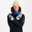 Snowboarder in a beanie crossing his arms wearing XTM Valentino Ascent Snow Leopard mitts
