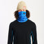 Model wearing the XTM Valentino neck tube in blue Snow Leopard print pulled up over the nose, front view
