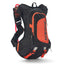 USWE Moto Hydro 12L in black with an orange front panel and orange buckles