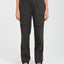 Woman wearing XTM Acacia hiking pants in Pirate Black with belt and leg flap pockets, front view