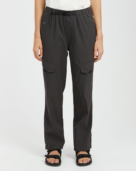 Woman wearing XTM Acacia hiking pants in Pirate Black with belt and leg flap pockets, front view