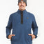 Man wearing the XTM Frazer pullover fleece in Slate Blue, hands in the zip pockets, front view