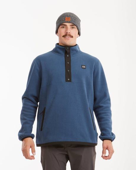 Front view of the Slate Blue XTM Frazer fleece with black snap placket and zip pockets