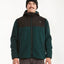 Man wearing the XTM Treachery sherpa jacket in Pine with black yoke and hood, front view