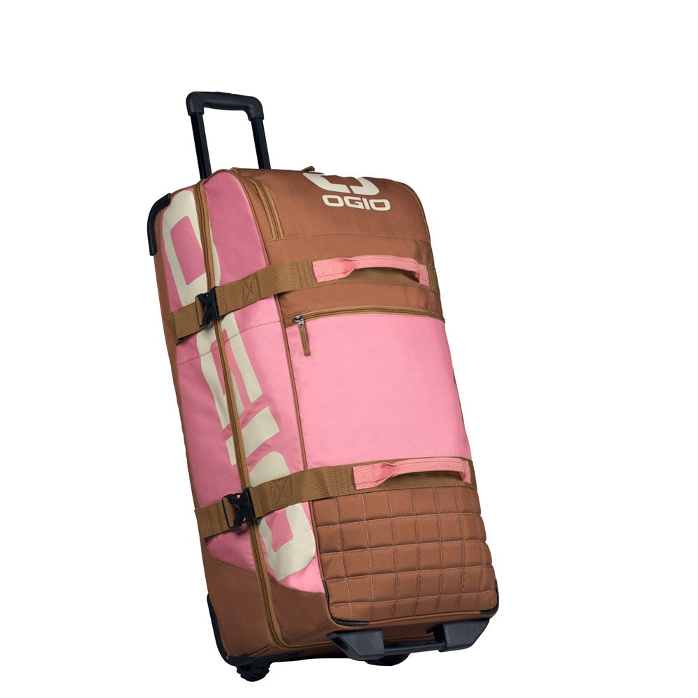 OGIO Trucker Gear Bag in Pink/Brown, three-quarter view with telescopic handle raised