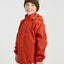 Boy in the XTM Kids Stash 2L packable rain jacket in Burnt Orange, three-quarter front view