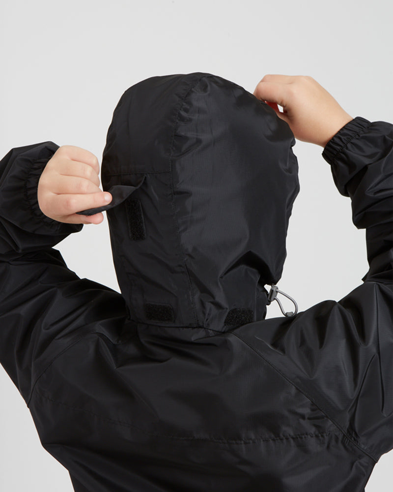 Rear close-up of the XTM Kids Stash 2L rain jacket hood in Black, showing the back hood adjuster