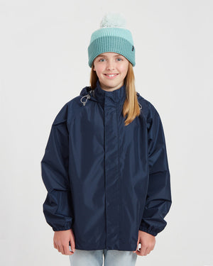 Girl wearing the XTM Kids Stash 2L packable rain jacket in Patriot Blue, front view