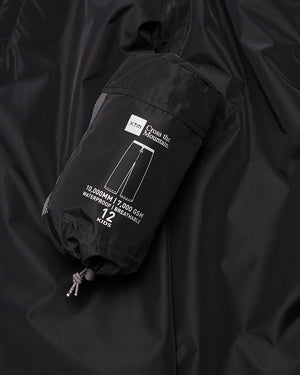 XTM Kids Stash 2L rain pant packed down small, label showing 10,000 mm waterproof rating