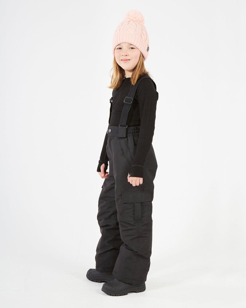 XTM Kids Pluto II Snow Pant in Black, side view on a child showing the leg pocket