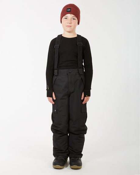 XTM Kids Scoobie II Ski Pant in Black, front view on a boy with braces over a black top