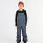 XTM Kids Bailey Ski Pant in Indigo Solid, front view on a child showing the chest panel