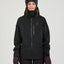 Woman wearing the black XTM Solitaire hardshell ski jacket, front view with chest zip pockets