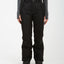 Front view of the black XTM Smooch women's ski pants with snap waist and side pockets