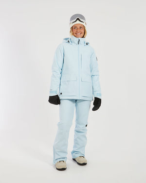 Full-length view of a woman in the Sky Blue XTM Elevation II ski jacket and pants