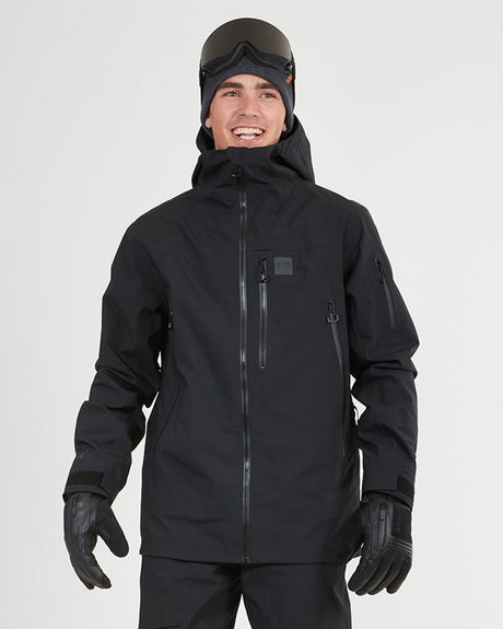 XTM Paradigm men's ski jacket in Black, front view on a model wearing goggles and gloves