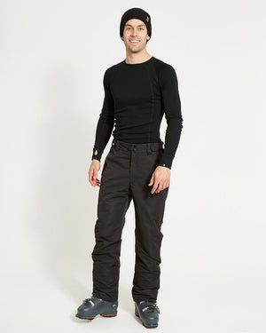 Full-length view of a model wearing the Black XTM Glide ski pant with a black base layer