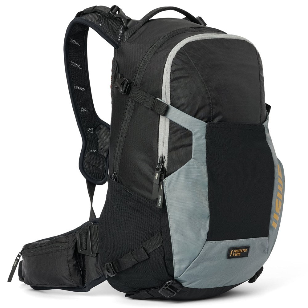 USWE Watt 25L E-MTB protector pack in black and grey, front three-quarter view with harness and waist belt