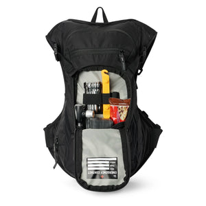 USWE MTB Hydro 9L in Black with the front pocket open, holding a multi-tool, a pump and snacks