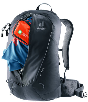 Deuter AC Lite 23 with the front zip open, showing a first aid kit and jacket in the main compartment