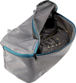 Grey shoe compartment of the Deuter Access 55 with blue zip trim, holding walking shoes