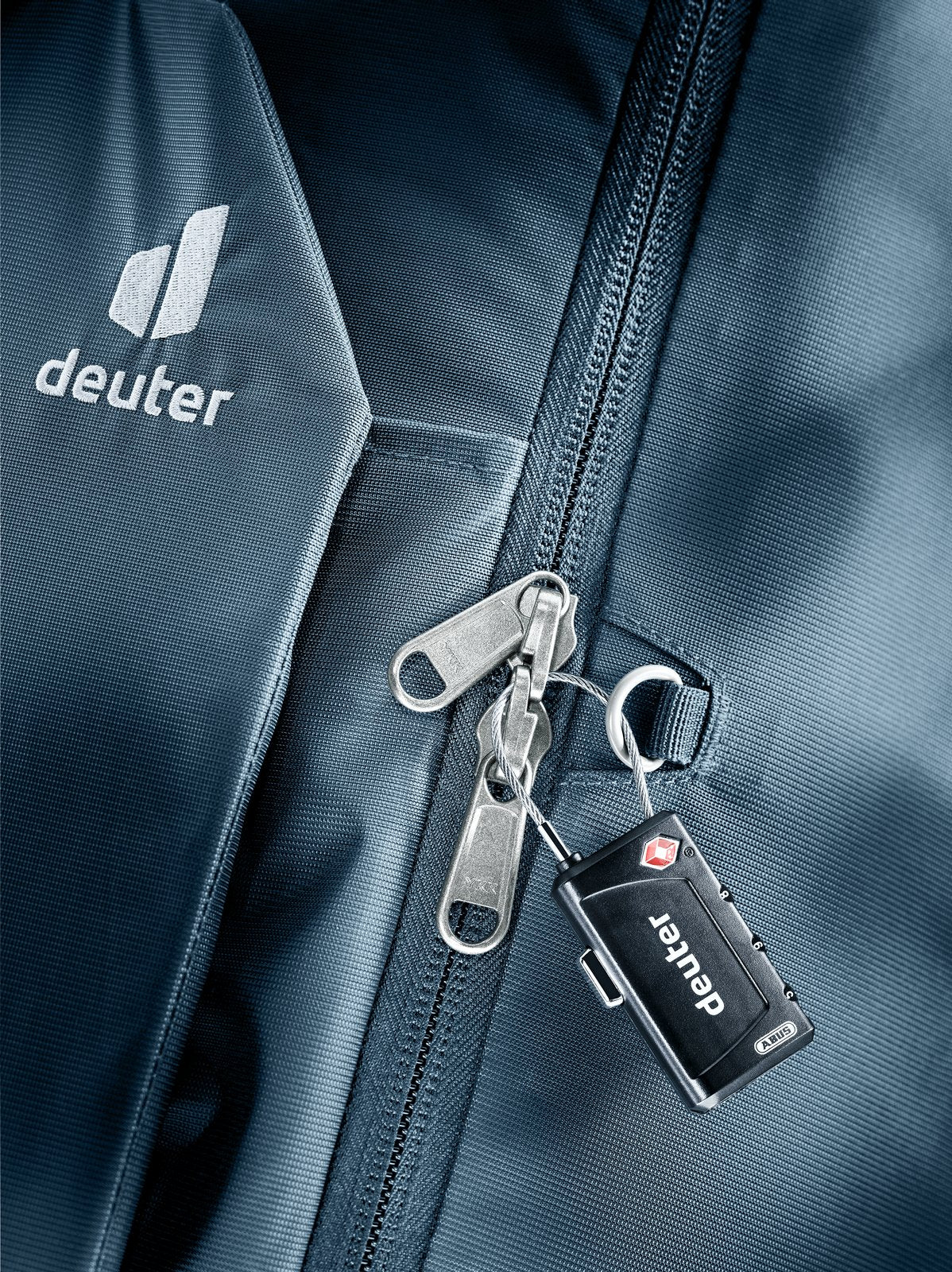 Close-up of a combination padlock on the Deuter Access Pro 65 main zip in Atlantic Ink