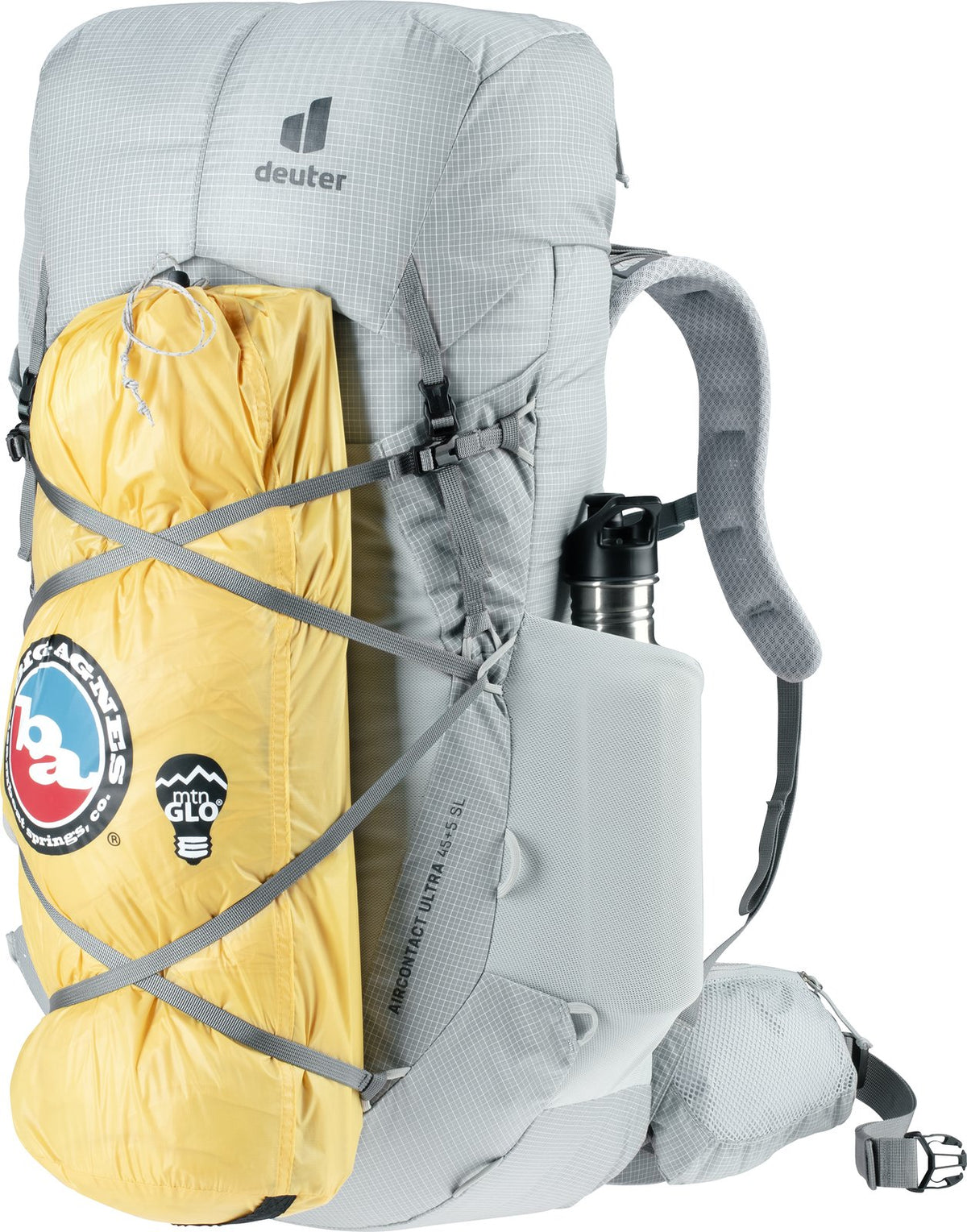 Deuter Aircontact Ultra 45+5 SL with a yellow tent bag strapped to the front and a bottle in the side pocket