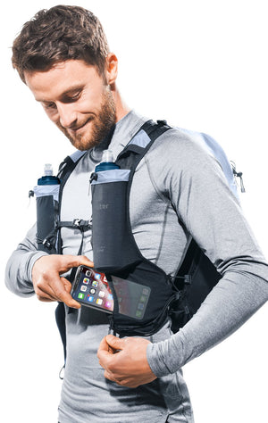 Runner putting a phone into the zipped shoulder strap pocket of the Deuter Ascender 7