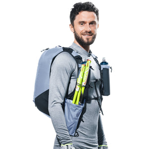 Runner wearing the Deuter Ascender 7 in Polar with folded poles in the front holster
