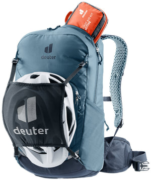 Deuter Bike I 20 in Atlantic Ink with a helmet in the mesh helmet holder and a first aid kit on top
