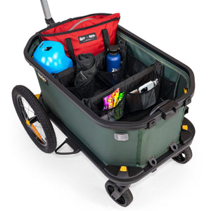 Burley Hopper cargo area split by the dividers, holding a red bag, blue helmet, drink bottle and snacks